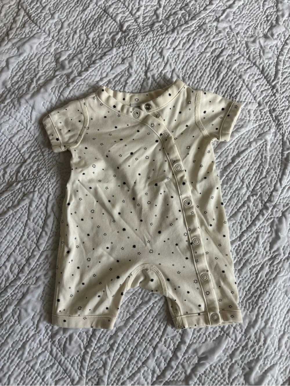 Hanna Andersson Cream Newborn Jumpsuit with Black Star Print
